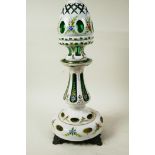 A Bohemian flash cut white over green glass lamp base and shade painted with flowers and gilt
