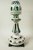 A Bohemian flash cut white over green glass lamp base and shade painted with flowers and gilt