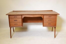 A Danish mid century teak, two sided desk designed by 'Svend and Madsen' for Sigurd Hansen, 59" x