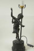 A bronzed metal table lamp cast as a figure of a dancing girl on a plinth base, 17" high