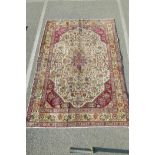 A vintage cream ground Persian Tabriz carpet, with wear and repairs, 81" x 113"