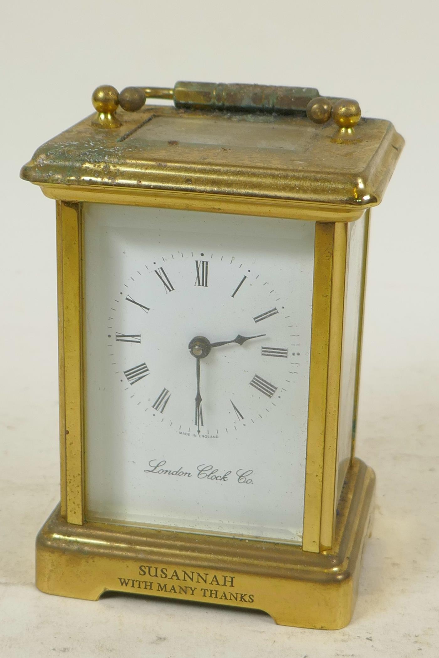 A brass cased carriage clock from the London Clock Company with white enamel dial and Roman
