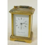 A brass cased carriage clock from the London Clock Company with white enamel dial and Roman