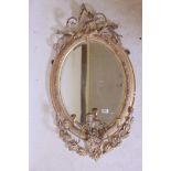 A C19th giltwood and composition wall mirror with laurel leaf and scrolling decoration and three