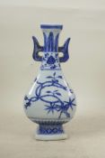 A Chinese blue and white porcelain two handled vase, decorated with branches in bloom, 4 character