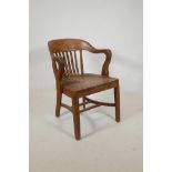 An early C20th American oak desk chair by 'Pound & Moore Co., Charlotte N.C.' (North Carolina),