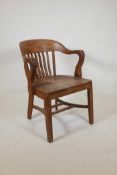 An early C20th American oak desk chair by 'Pound & Moore Co., Charlotte N.C.' (North Carolina),