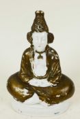 A Continental porcelain pastille burner modelled as a figure seated in meditation, 4" high