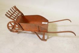A well constructed copper model of a wheelbarrow, 17" x 7" x 7"