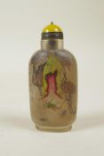A Chinese reverse decorated glass snuff bottle depicting insects and fruit, 3½" high