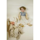 A C19th German doll with bisque head and articulated limbs having opening eyes and four teeth,