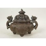 A Chinese antique bronze censer and cover with two dragon handles and all over dragon decoration,