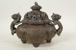 A Chinese antique bronze censer and cover with two dragon handles and all over dragon decoration,