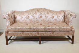 A vintage camel back settee on fluted square walnut supports upholstered in floral silk fabric,