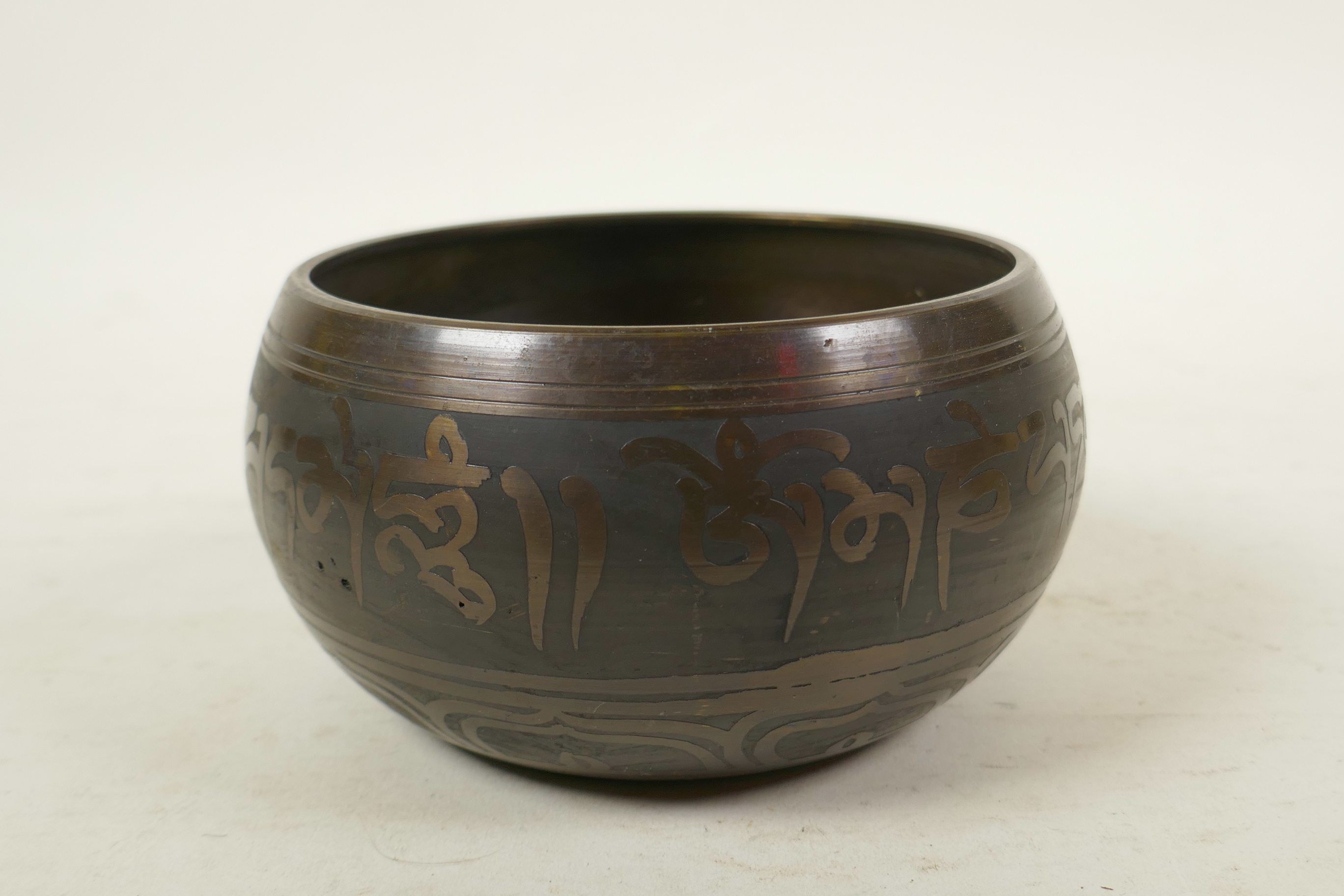 A Tibetan gilt bronze singing bowl, and another with character script decoration to exterior and - Image 4 of 7