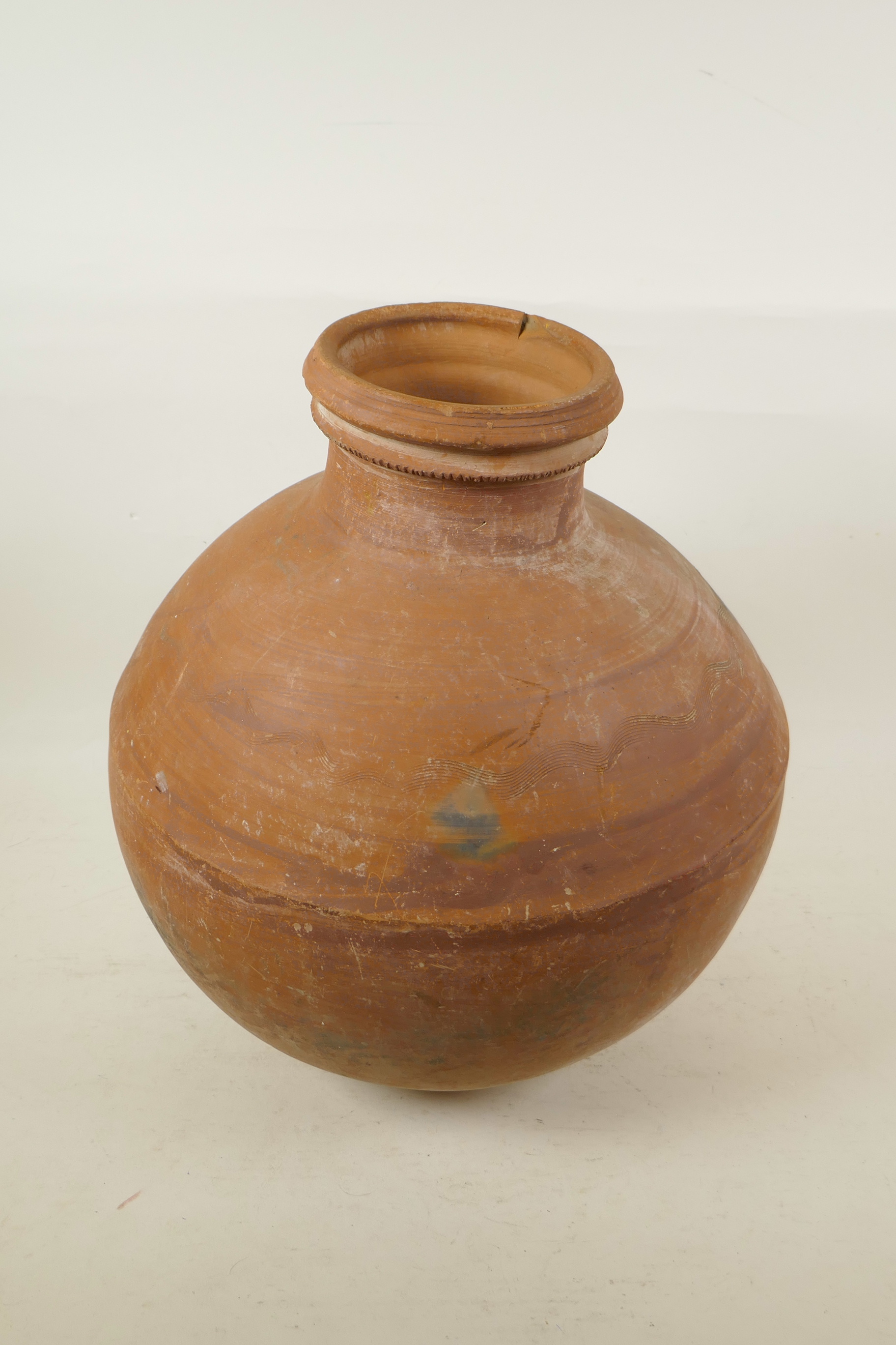 An Indian terracotta water vessel of globular form, 14" high, A/F chip to rim - Image 2 of 3