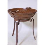 A bowl shaped iron fire pit on wrought iron stand, 18" high, 16" diameter