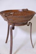 A bowl shaped iron fire pit on wrought iron stand, 18" high, 16" diameter