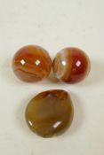 A pair of agate meditation balls, together with a Chinese carved agate pendant in the form of a