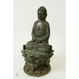 A Sino-Tibetan bronze figure of Buddha seated on a lotus throne, 8½" high