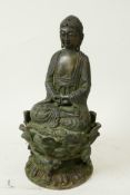 A Sino-Tibetan bronze figure of Buddha seated on a lotus throne, 8½" high