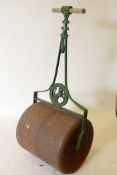 A vintage wrought metal garden roller, 44" high