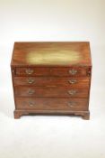 A George III mahogany fall front bureau, the fitted interior with inset baize cover over four long