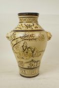 A Chinese Cizhou pottery vase with two lion mask handles, decorated with a sage and apprentice in
