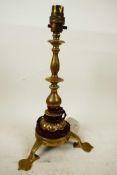 An Art Nouveau brass table lamp with compound brass column and three spade feet, 13" high