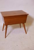 A mid-century sapele mahogany workbox with lift up top, raised on splay supports, 21" x 15" x 20"