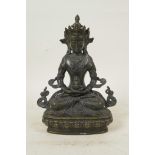 A Sino-Tibetan bronze of Buddha seated on a lotus throne, 9" high