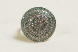 A silver gilt cluster ring set with concentric circles of diamonds and emeralds, approx size O/P