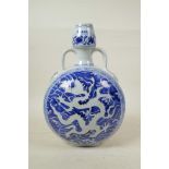 A Chinese Ming style blue and white porcelain garlic head shaped flask with two handles, decorated