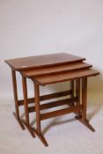 A nest of three mid-century shaped top teak occasional tables, 24" x 17" x 21"