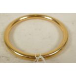 A hollow gold bangle, marked 15ct, 3" diameter, gross 16 grams