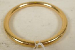 A hollow gold bangle, marked 15ct, 3" diameter, gross 16 grams