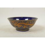 A Chinese powder blue ground porcelain bowl with coppered dragon decoration, 6 character mark to