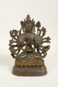 A Sino Tibetan bronze figure of a many armed deity, remnants of gilt and lacquer patina, 7" high
