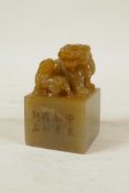 A Chinese soapstone seal with carved kylin knop and character inscription to side, 3½" high, 2" x 2"