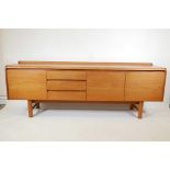 A 1960s/70s teak sideboard by White & Newton, with three drawers and three doors, 82" x 18", 30"
