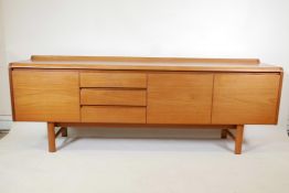 A 1960s/70s teak sideboard by White & Newton, with three drawers and three doors, 82" x 18", 30"