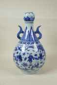 A Chinese blue and white porcelain garlic head shaped vase with two handles, decorated with the