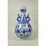 A Chinese blue and white porcelain garlic head shaped vase with two handles, decorated with the