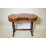 A kidney shaped burr walnut writing table, the shaped top with single frieze drawer on two turned