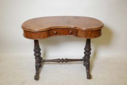 A kidney shaped burr walnut writing table, the shaped top with single frieze drawer on two turned