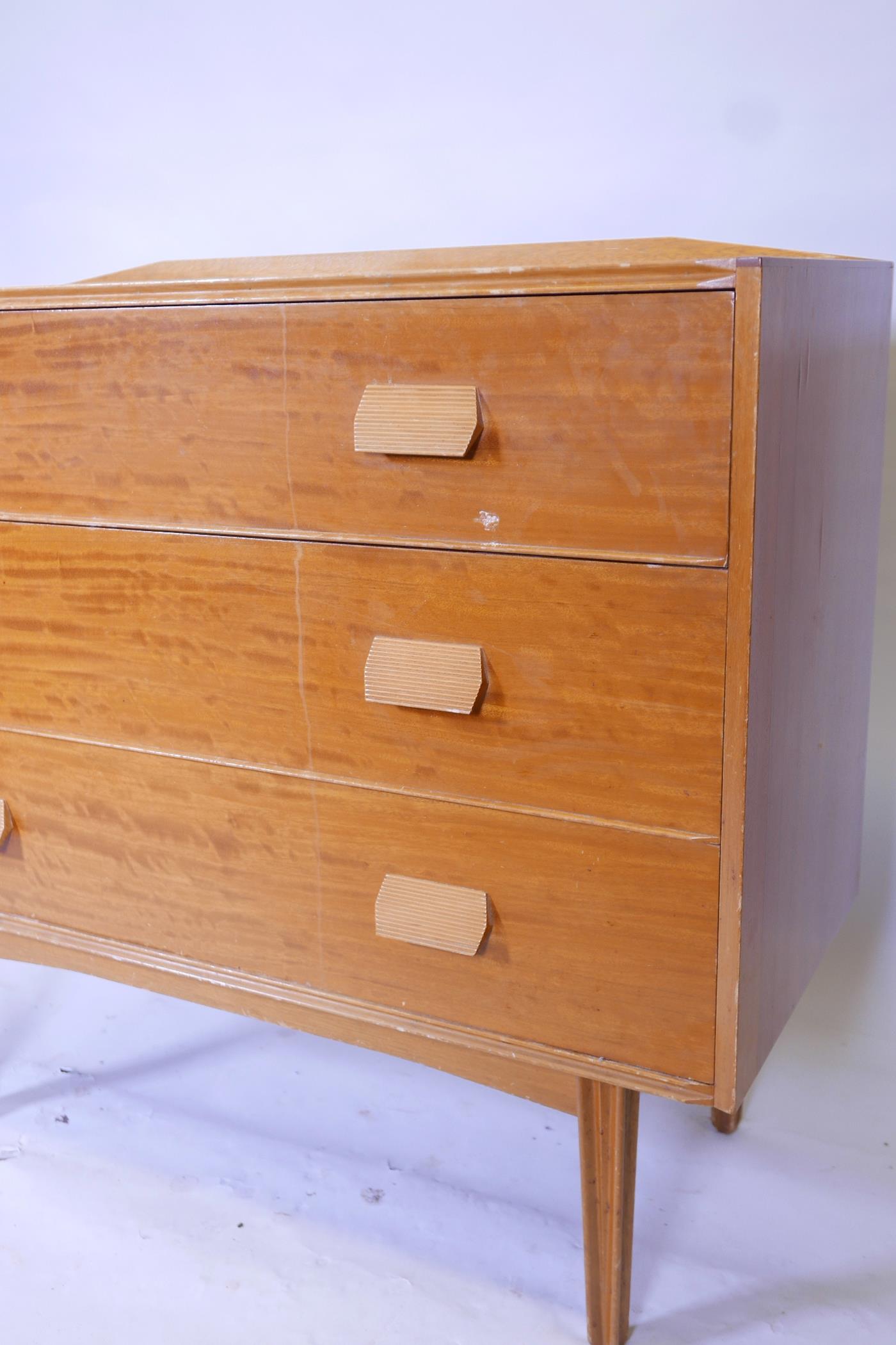 A mid C20th chest of three long drawers raised on ribbed, tapered supports, 42" wide, 37" long, - Image 2 of 2