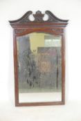An Edwardian mahogany framed wall mirror adapted from a dressing table mirror with elaborately