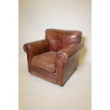 A Thomas Lloyd leather upholstered armchair on turned supports