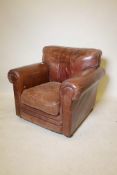 A Thomas Lloyd leather upholstered armchair on turned supports