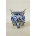A Chinese blue and white porcelain two handled censer on tripod feet, decorated with dragons chasing
